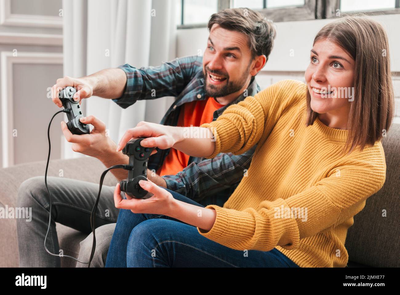 Beautiful couple playing video games console Stock Photo