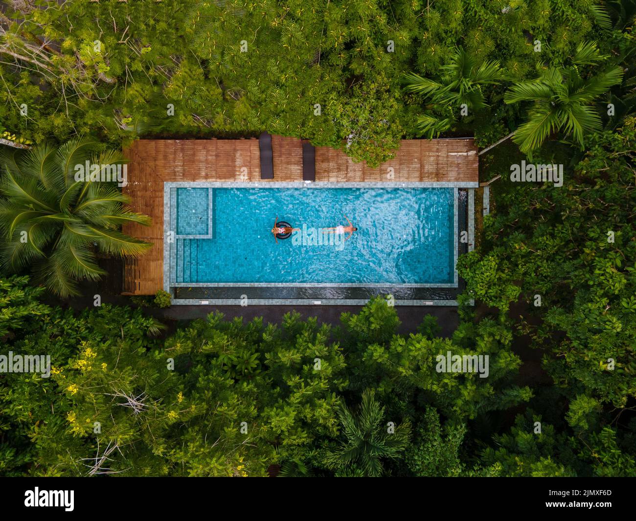 Aerial view of swimming pool in the jungle of Krabi Thailand, couple in pool, men and woman in pool Stock Photo