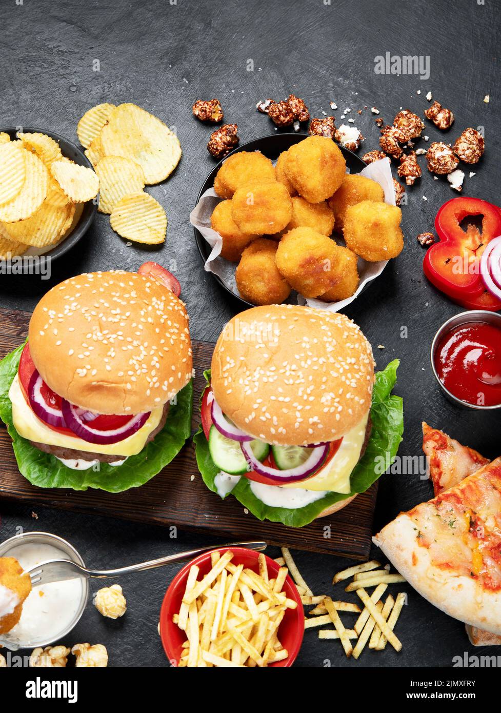 Fast food and unhealthy eating concept - close up of fast food snacks ...