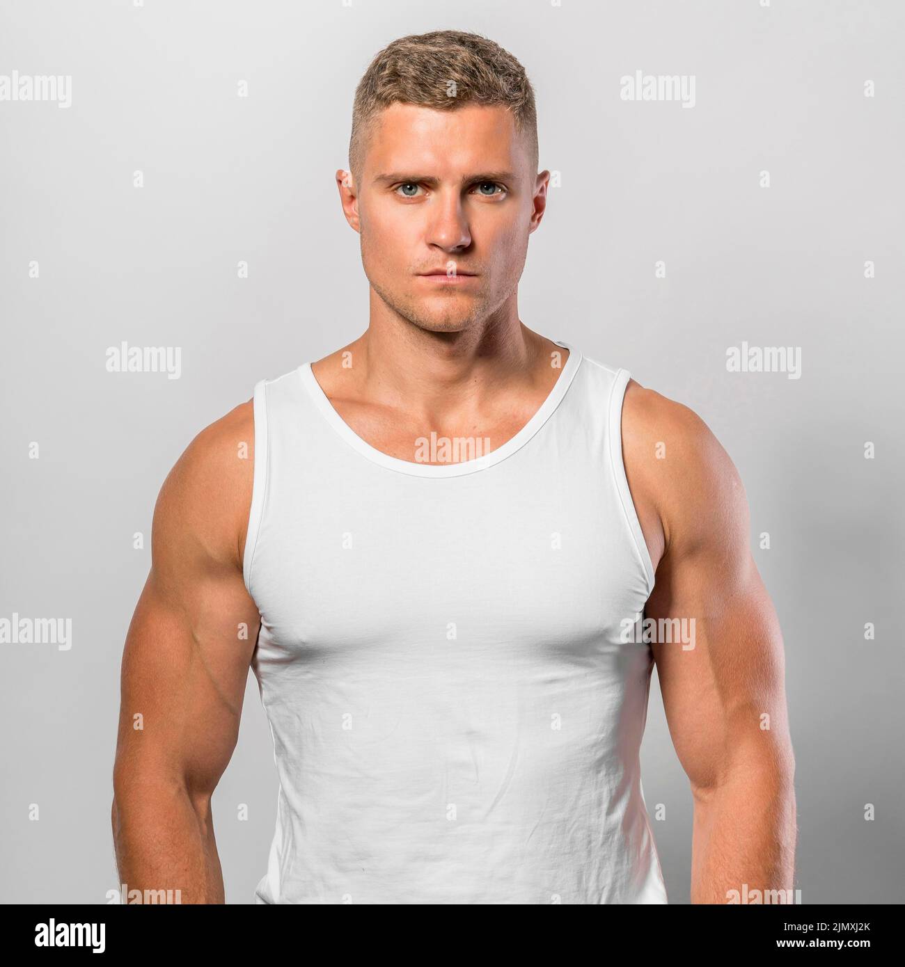 Very fit man posing while wearing tank top Stock Photo Alamy