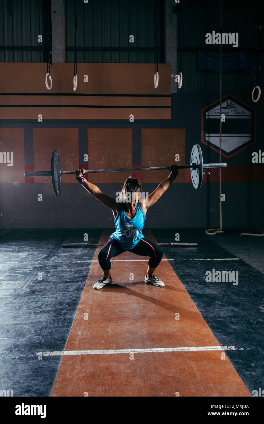 Woman lifting bar Stock Photo