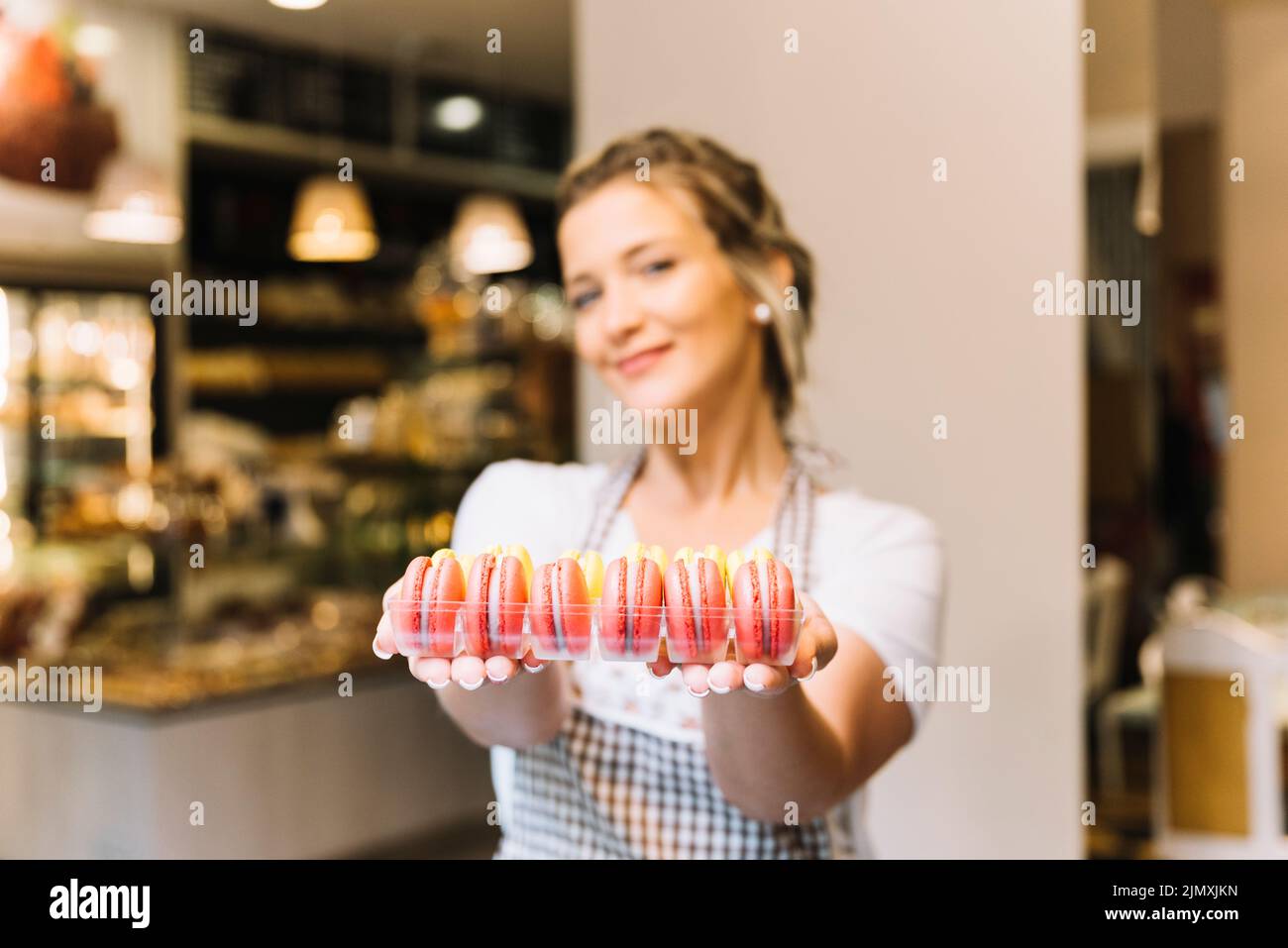 Waitress offering macarons Stock Photo
