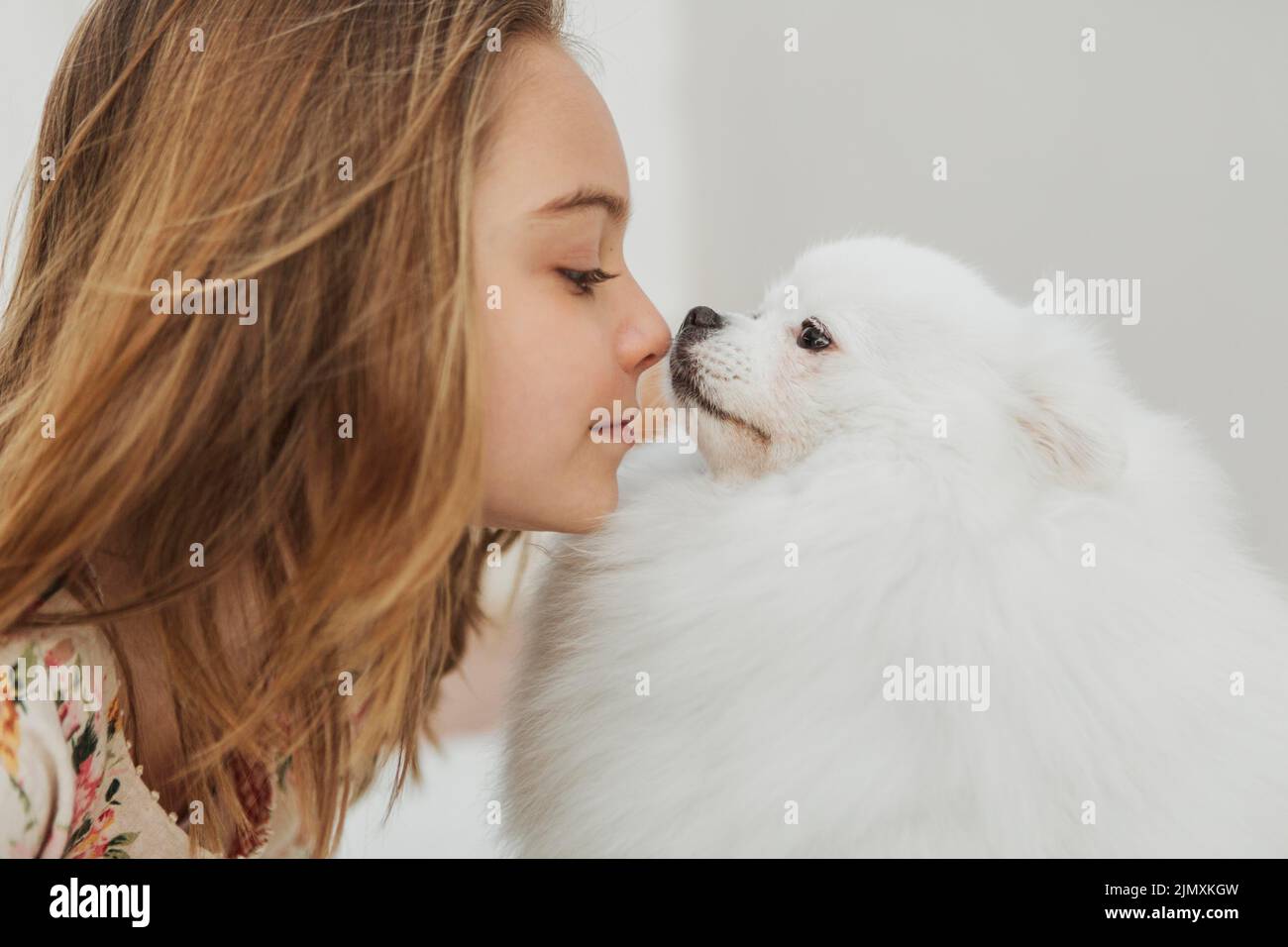 Girl dog touching noses Stock Photo