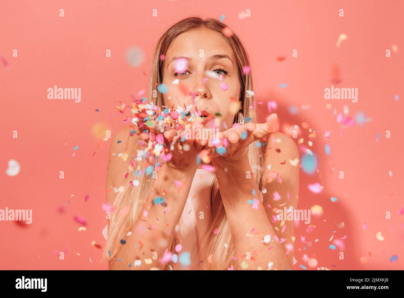 Girl blowing confetti Stock Photo