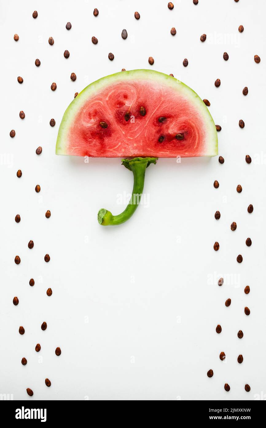 Top view watermelon umbrella with seeds white background Stock Photo