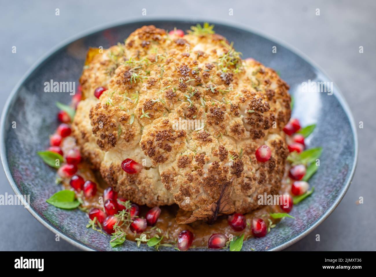 whole roasted oven baked cauliflower with spicy herbs Stock Photo - Alamy