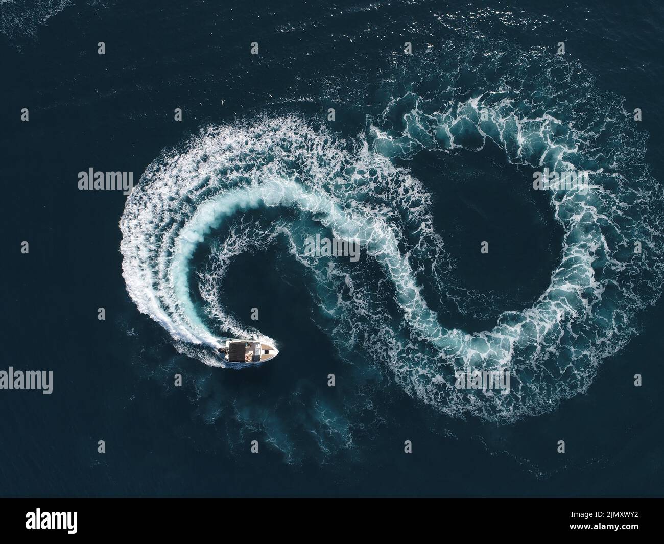 Boat Loop Path Aerial top view of a white pleasure boat on a summer day. Powerboat ...