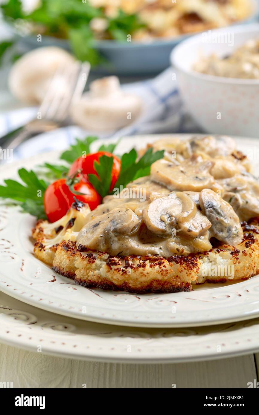 Cauliflower steak with mushrooms. Stock Photo