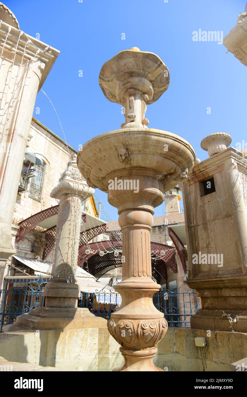 A gargoyle in shape of a human face of the water fountain built in 1903 by the Greek-Orthodox Patriarchate in neo Baroque style. Jerusalem, Israel. Stock Photo