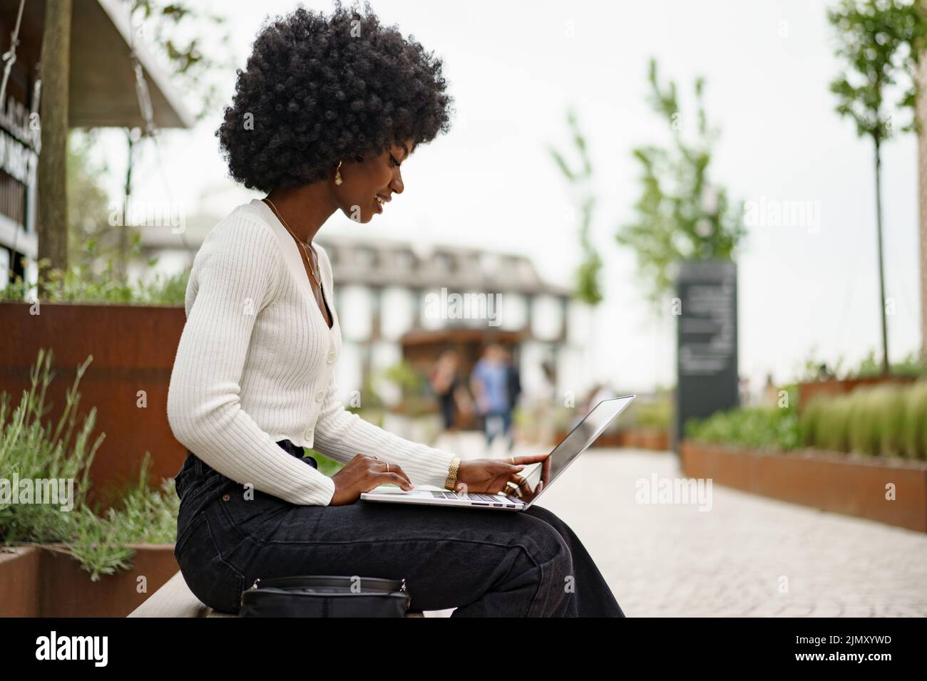 Young african american businesswoman working using laptop sitting on ...