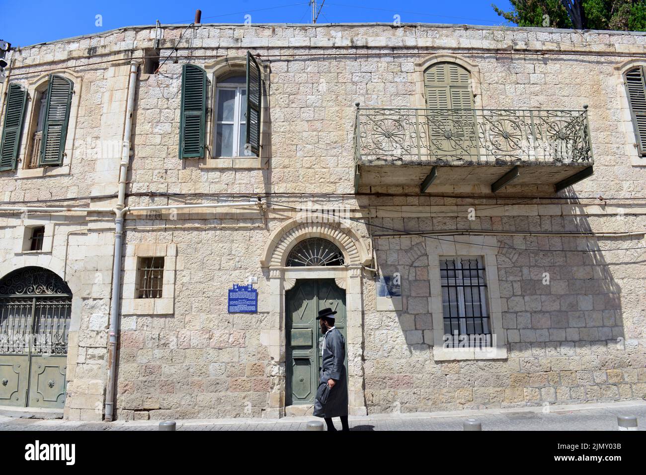 A Hassidic Jewish man walking by the historical Eliezer Ben-Yehuda's house on Ethiopia street in Jerusalem, Israel. Stock Photo