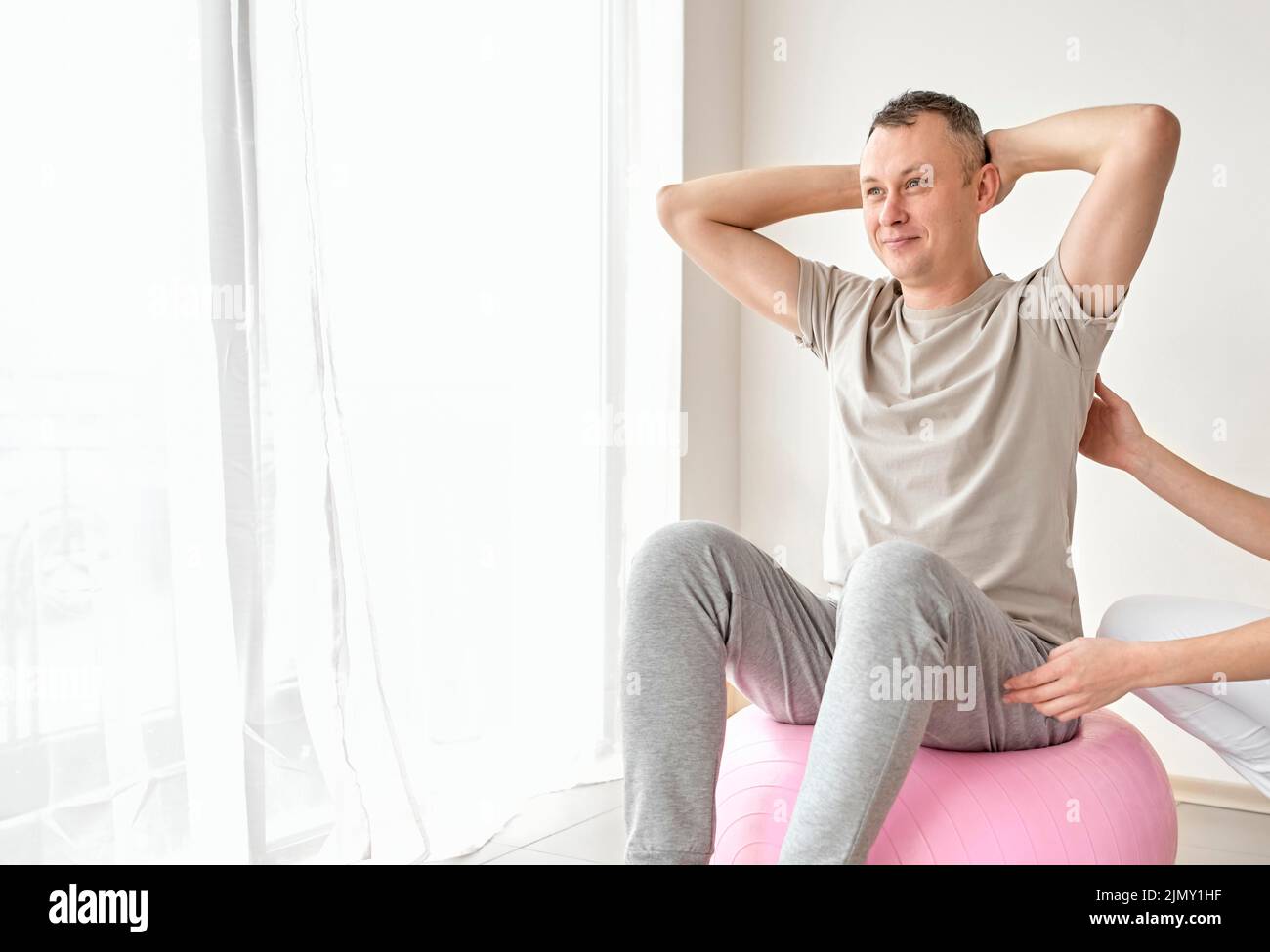 Therapist undergoing physical therapy with male patient Stock Photo