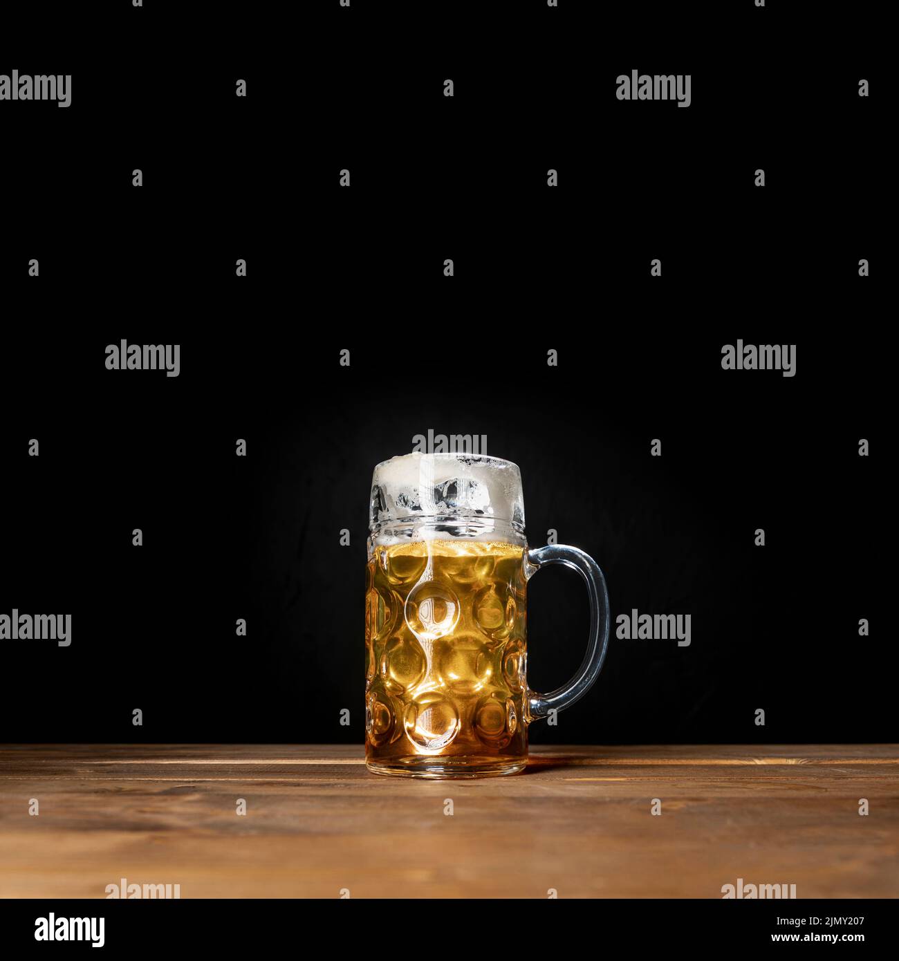Tasty mug bavarian beer with black background Stock Photo