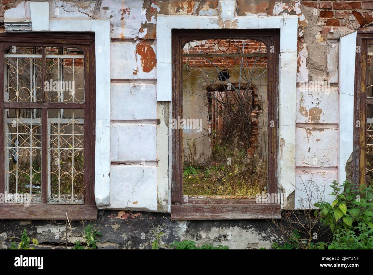 Windows and walls of an old ruined house on an autumn day Stock Photo