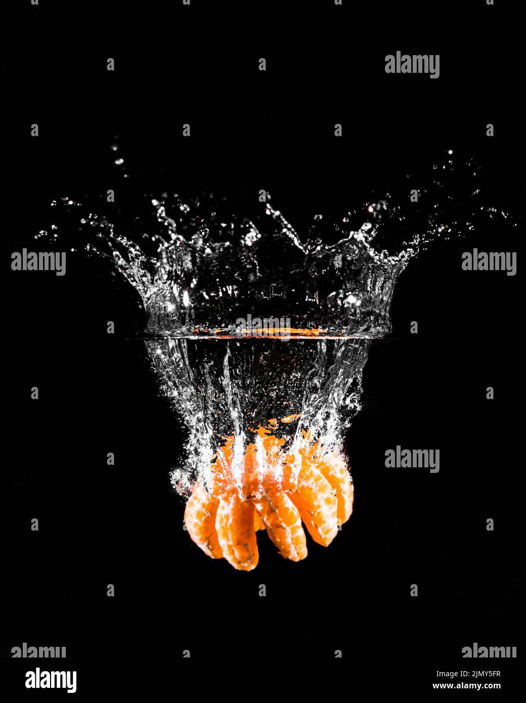 Mandarine plunging into water Stock Photo