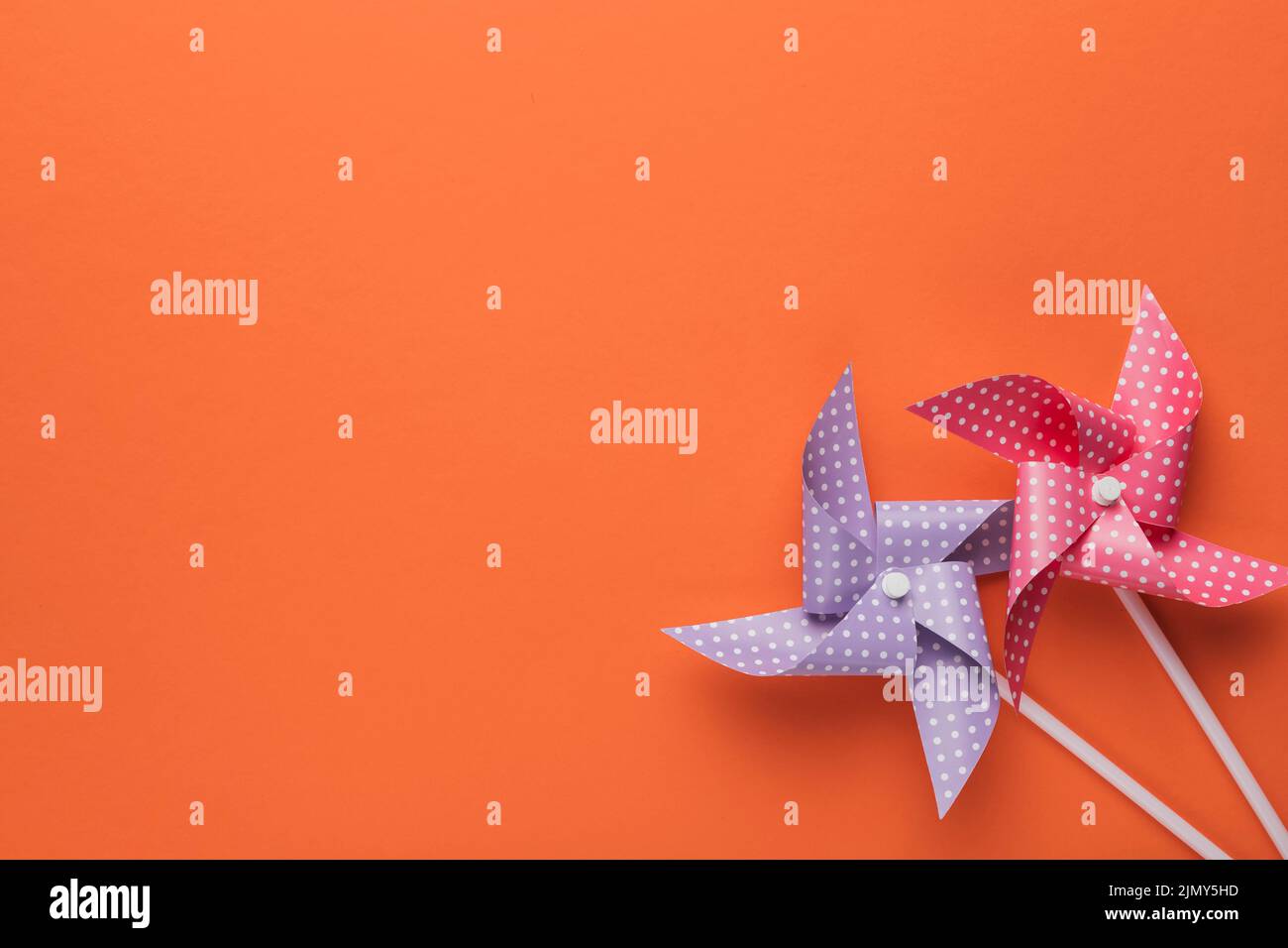 High angle view polka dotted pinwheel orange backdrop Stock Photo