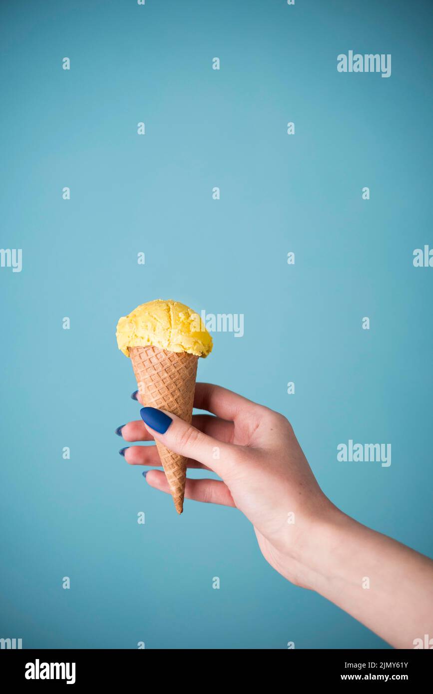Hand holding delicious ice cream cone Stock Photo - Alamy