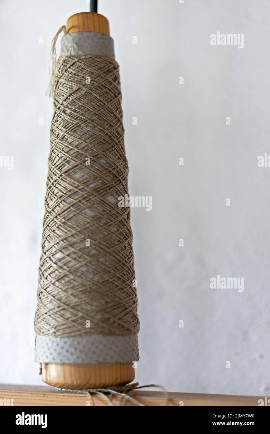 close up of a spindle with coiled yarn Stock Photo