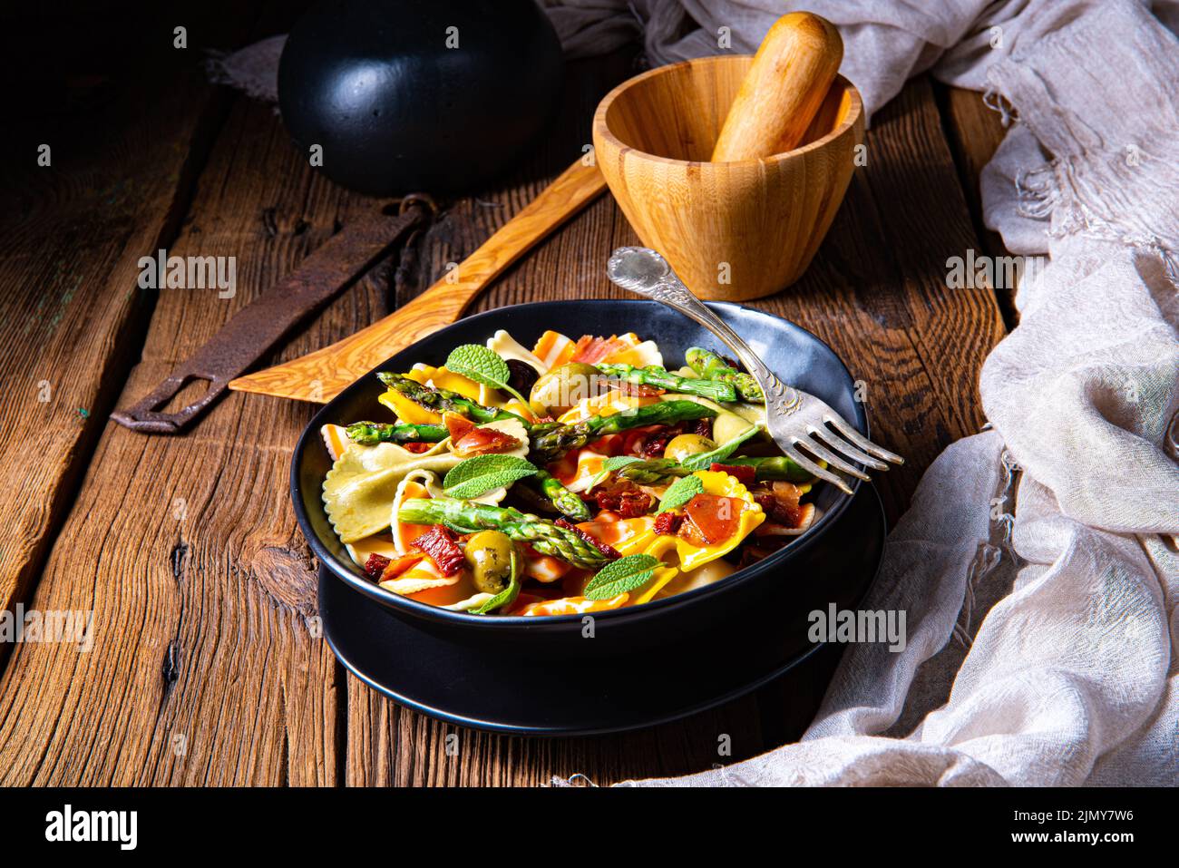 Pasta salad with green asparagus, olives and parma ham Stock Photo Alamy