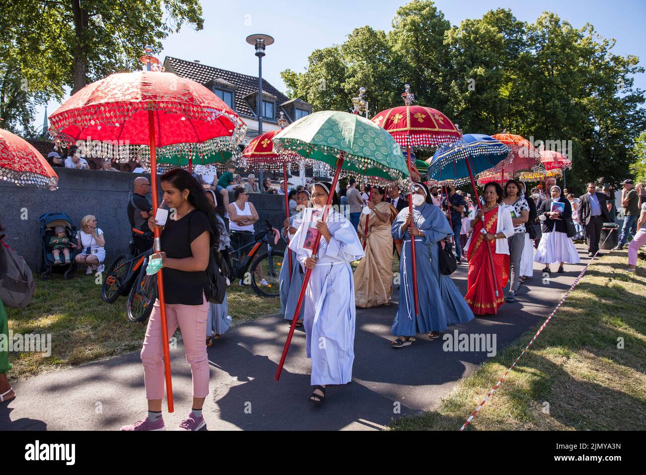 Corpus Christi ship procession Muelheimer Gottestracht on the river Rhine, Cologne, Germany. Members of the Indian community on the processional way t Stock Photo