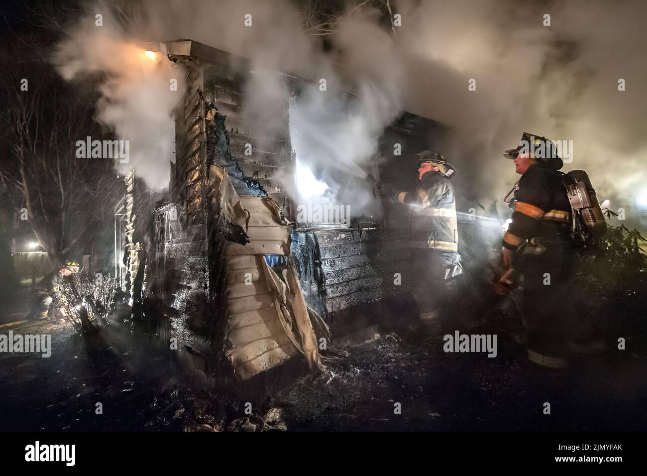 Members of the Bridgehampton Fire Department fight a fire in a fully