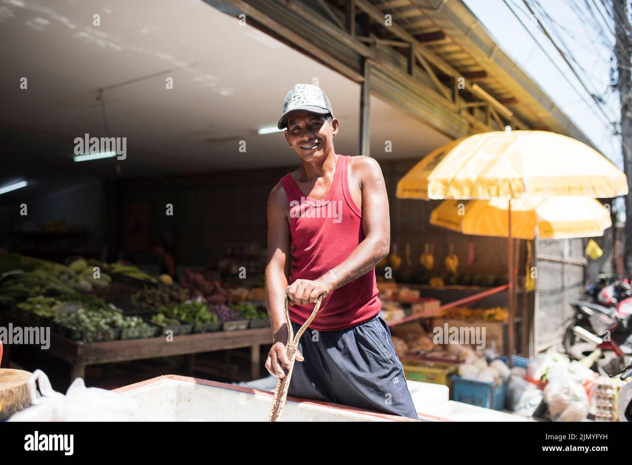 Portrait of man working in local fish shop. The colorful streets of Koh Tao Stock Photo