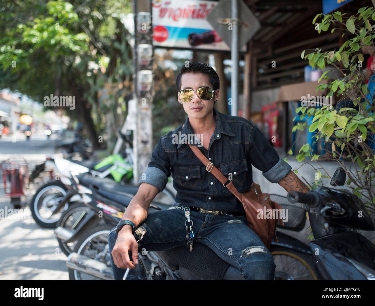Portrait of a shop worker who rents a motorcycle. Stock Photo
