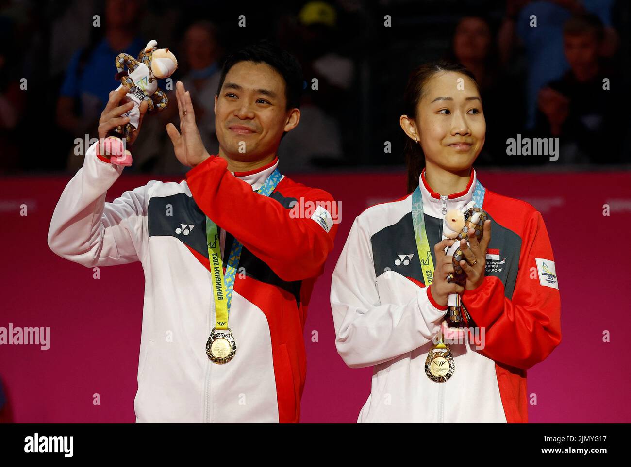 Commonwealth Games - Badminton - Mixed Doubles -Medal Ceremony -The NEC Hall 5, Birmingham, Britain - August 8, 2022 Gold Medallists Singapore's Yong Kai Terry Hee and Jessica Wei Han Tan celebrate on the podium during the medal ceremony REUTERS/Jason Cairnduff Stock Photo