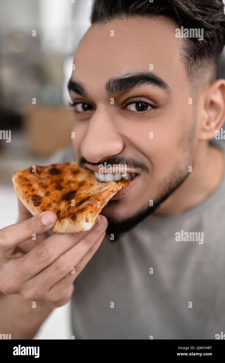 Close-up face of man eating pizza Stock Photo