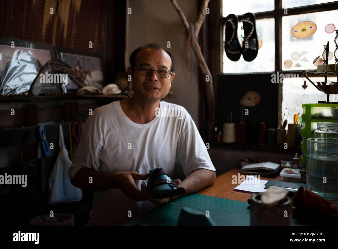 Local shoe shop. Shoe production workshop. Portrait of the shoemaker. Stock Photo