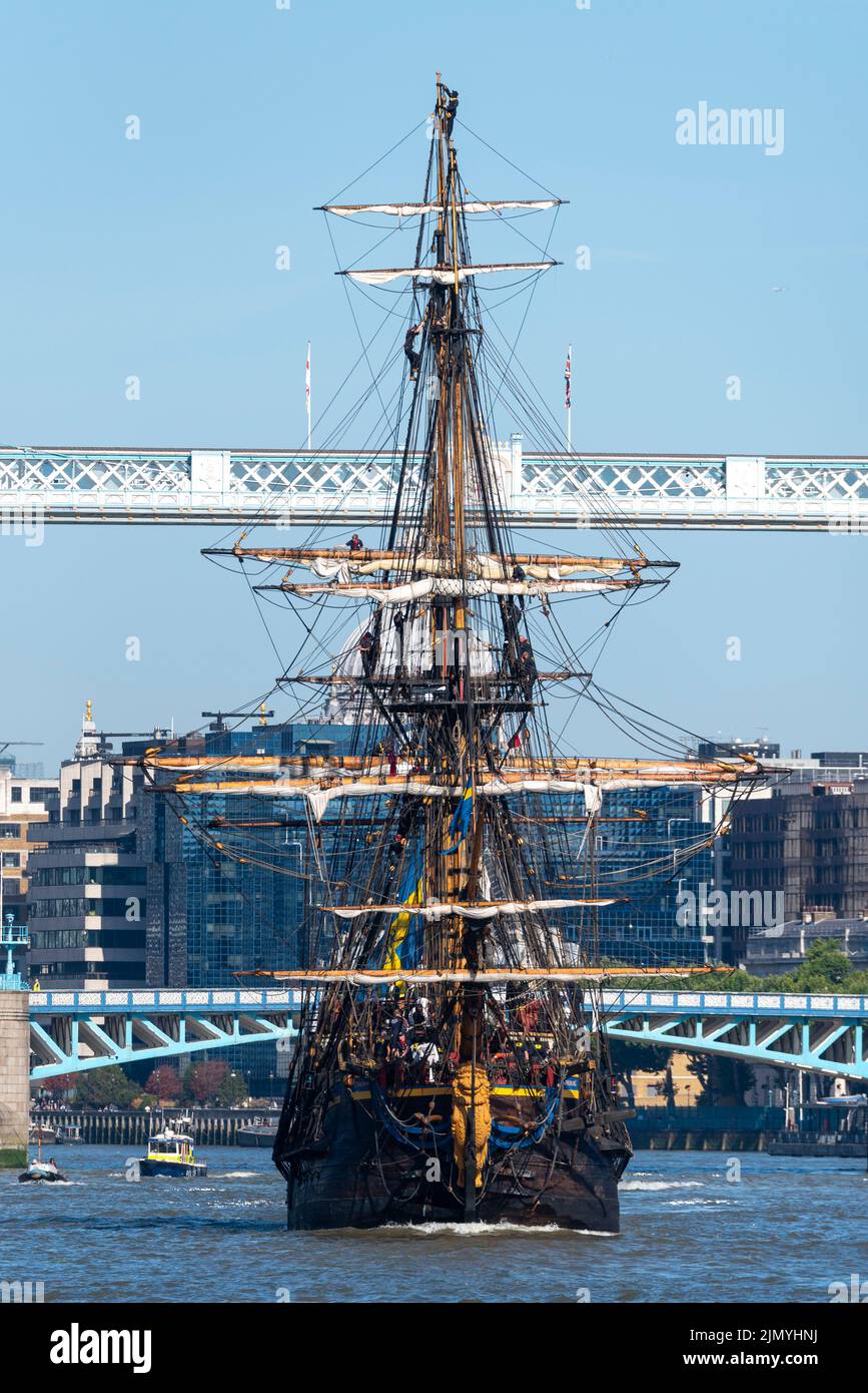 Tower Bridge, London, UK. 8th Aug, 2022. Gotheborg of Sweden is a sailing replica of the Swedish East Indiaman Gotheborg I, launched in 1738, and is visiting London to welcome visitors on board. The wooden replica ship was launched in 2003 and last visited London in 2007. It has navigated up the River Thames in the morning to pass under the opened Tower Bridge before turning and passing back under and heading for Thames Quay in Canary Wharf, where it will be open to visitors. Heading down river after passing under Tower Bridge Stock Photo