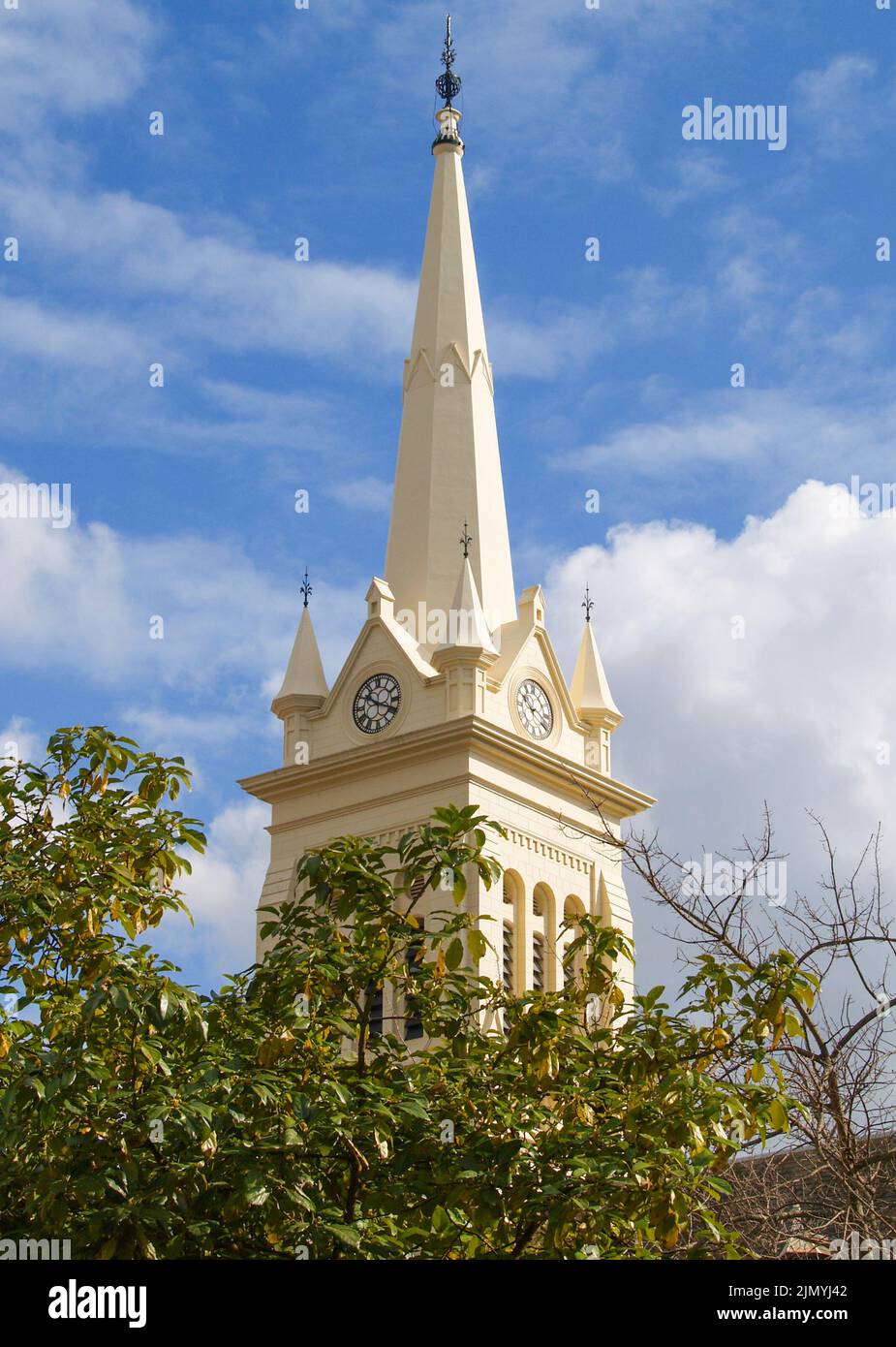 Church spire with clocks rising skyward Stock Photo