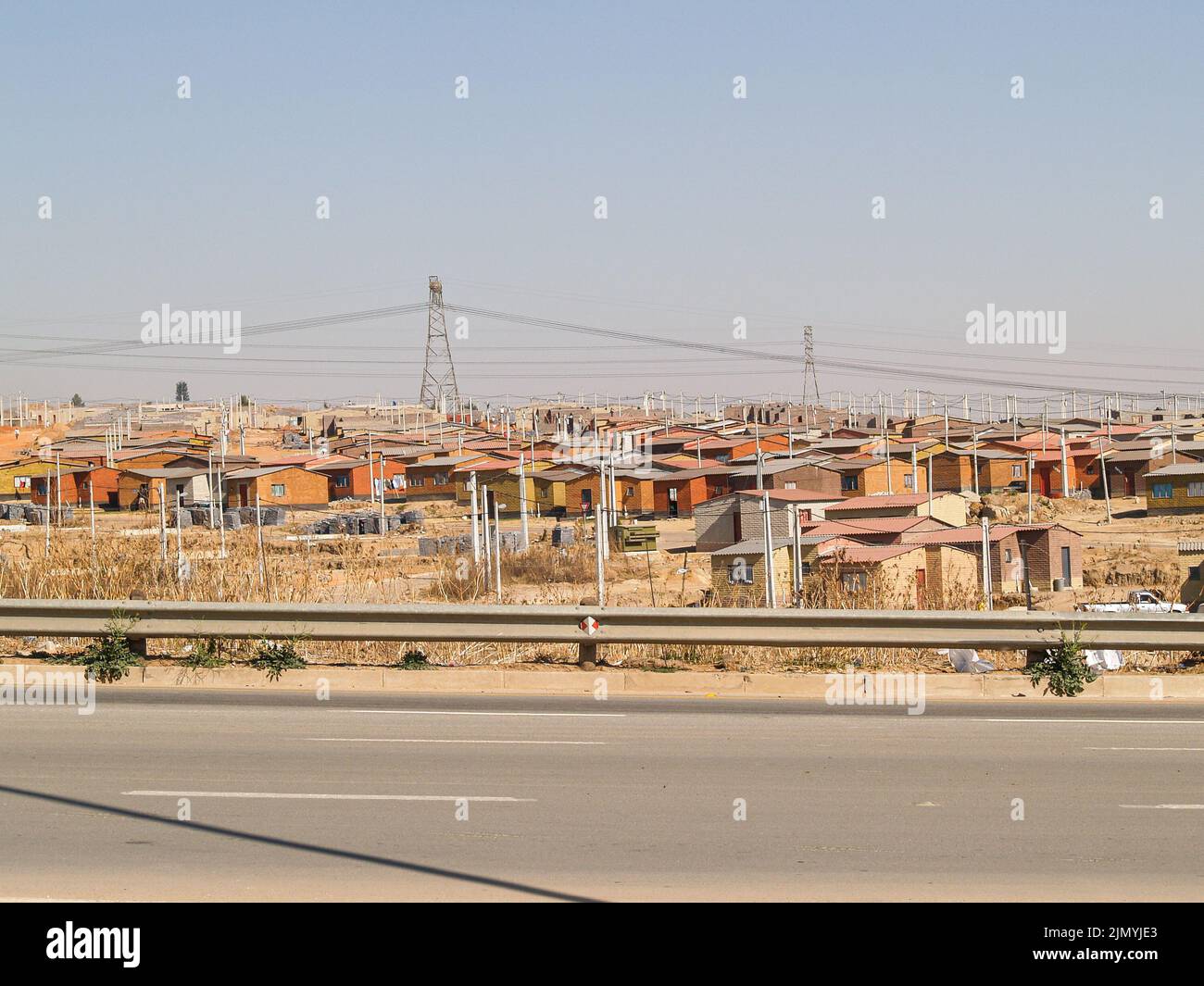 Area of low cost housing for poor along highway in South Africa.near Capetown. Stock Photo