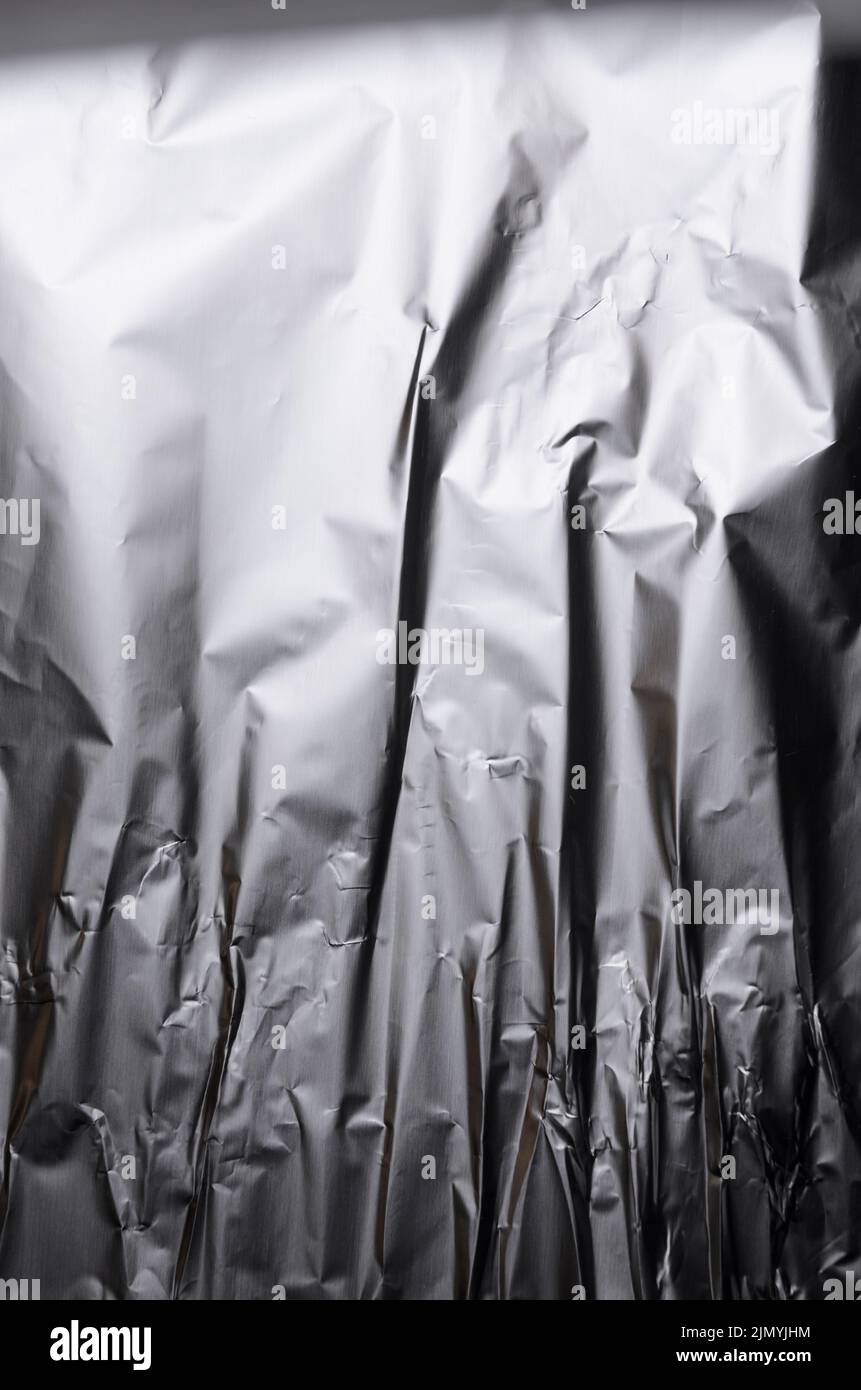 Abstract background of crumpled silver aluminium foil Stock Photo