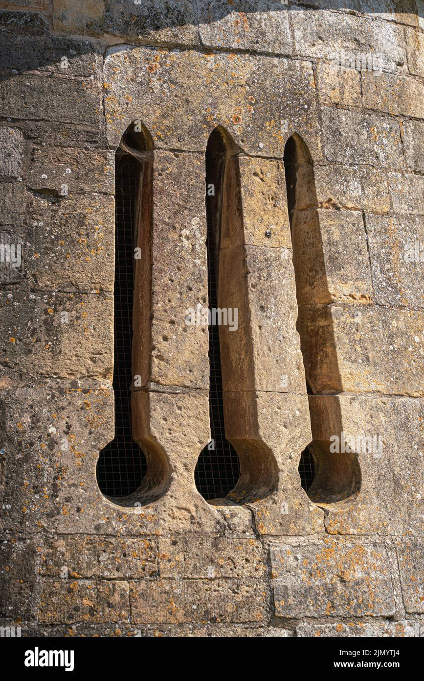 Arched, castle, window, medieval, stone, stonework, arrow slit, arrow slot, archer, fletcher, defence, ancient defence system, wall, military, bow. Stock Photo