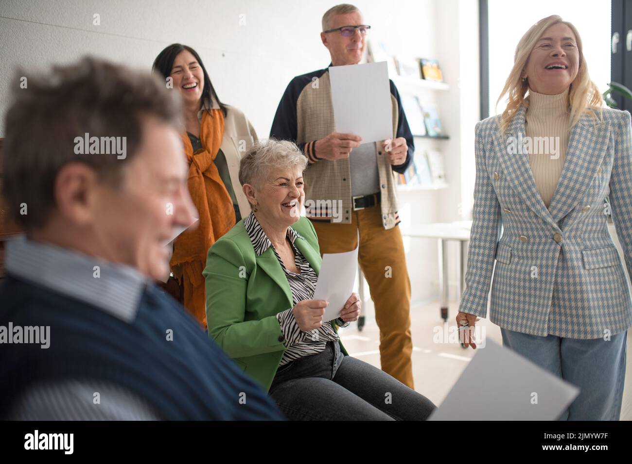 Group of seniors singing together at choir rehearsal. Stock Photo