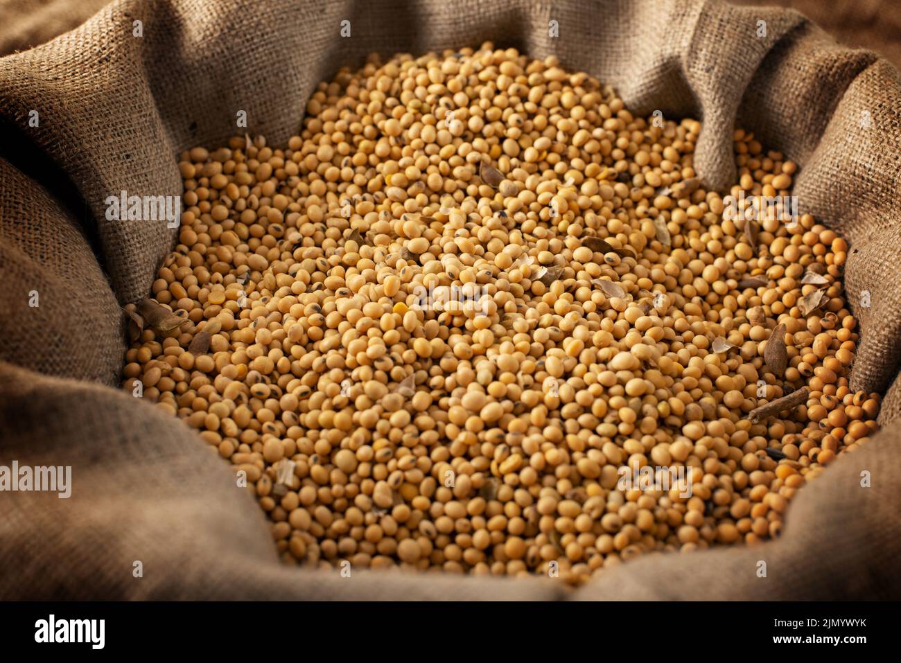 Food background of raw soybeans in burlap sack Stock Photo