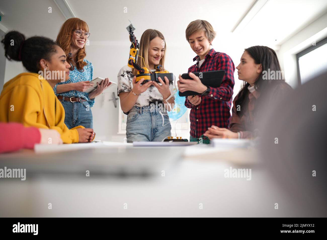 Group of students building and programming electric toys and robots at robotics classroom Stock Photo