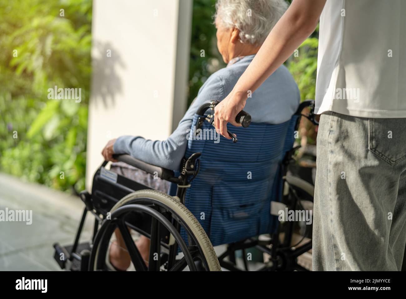 Caregiver help and care Asian senior or elderly old lady woman patient ...