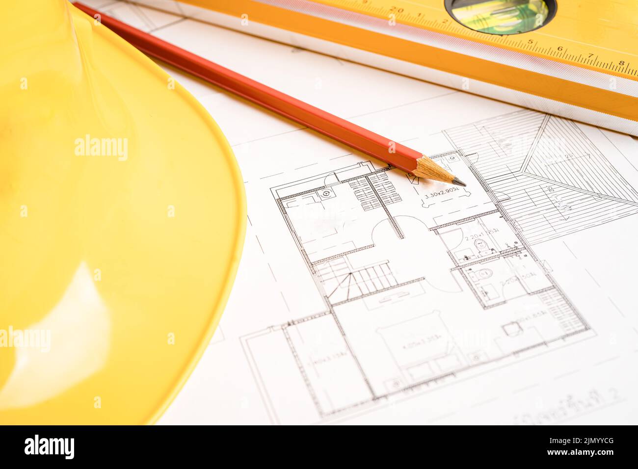 Architectural house plan project blueprint with yellow helmet and