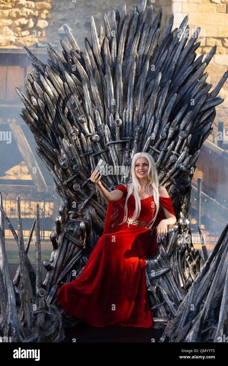 EDITORIAL USE ONLY Cosplayer and super fan Sophia sits on the Iron Throne outside the Tower of London to mark the launch of the Game of Thrones prequel, House of the Dragon, airing on Sky and streaming service NOW from August 22. PA PHOTO Picture date: Monday August 8, 2022.. The throne is being displayed at the Tower of London today and tomorrow, ahead of the House of the Dragon premiere next week in Leicester Square. Fans and Visitors to the Tower of London will be able to discover more about the news series via a QR code next to the Iron Throne. The Throne will then be touring the country,  Stock Photo