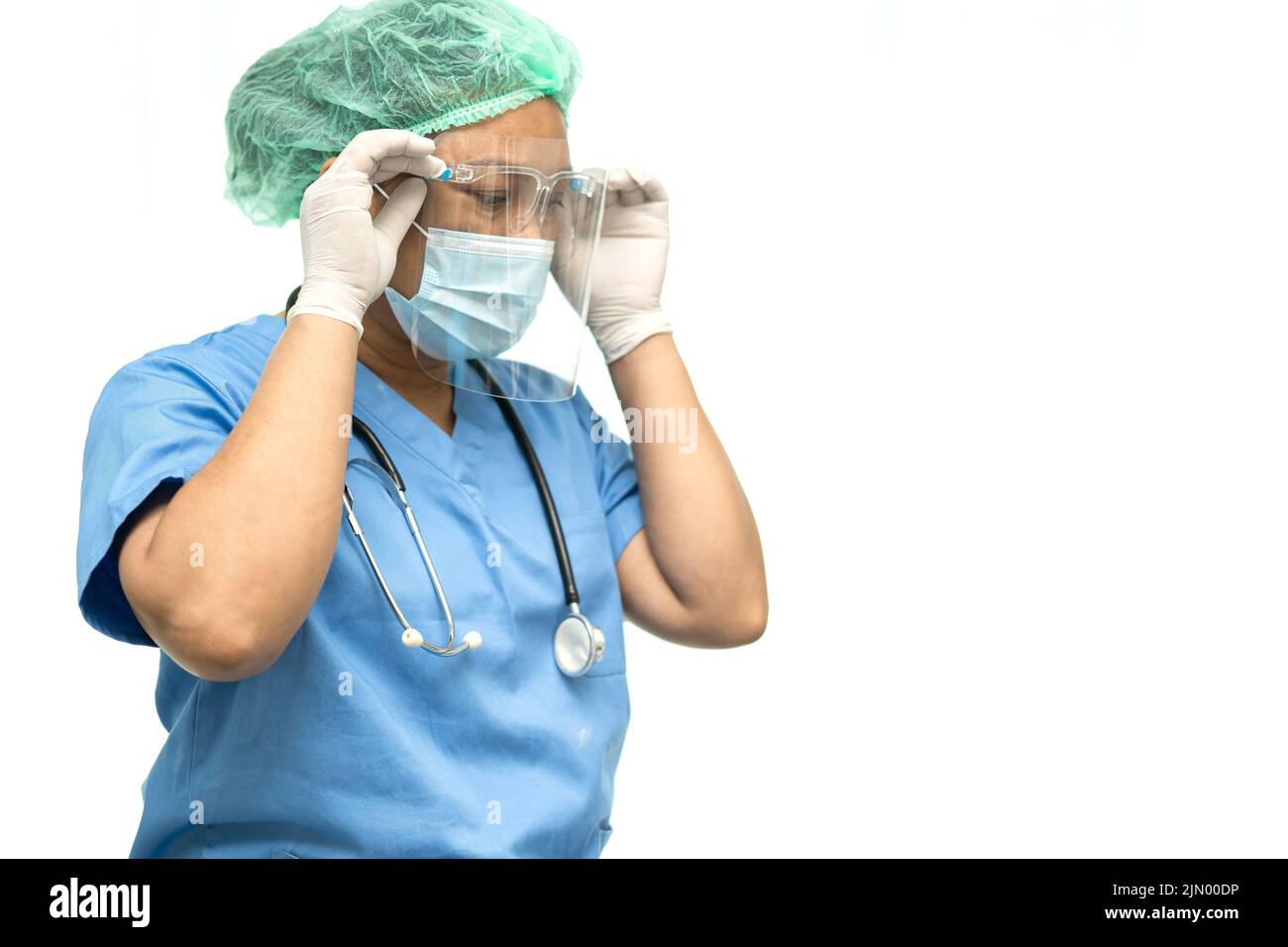 Asian doctor wearing face shield and PPE suit to check patient protect safety infection Covid 19 Coronavirus outbreak at hospital with copy space. Stock Photo