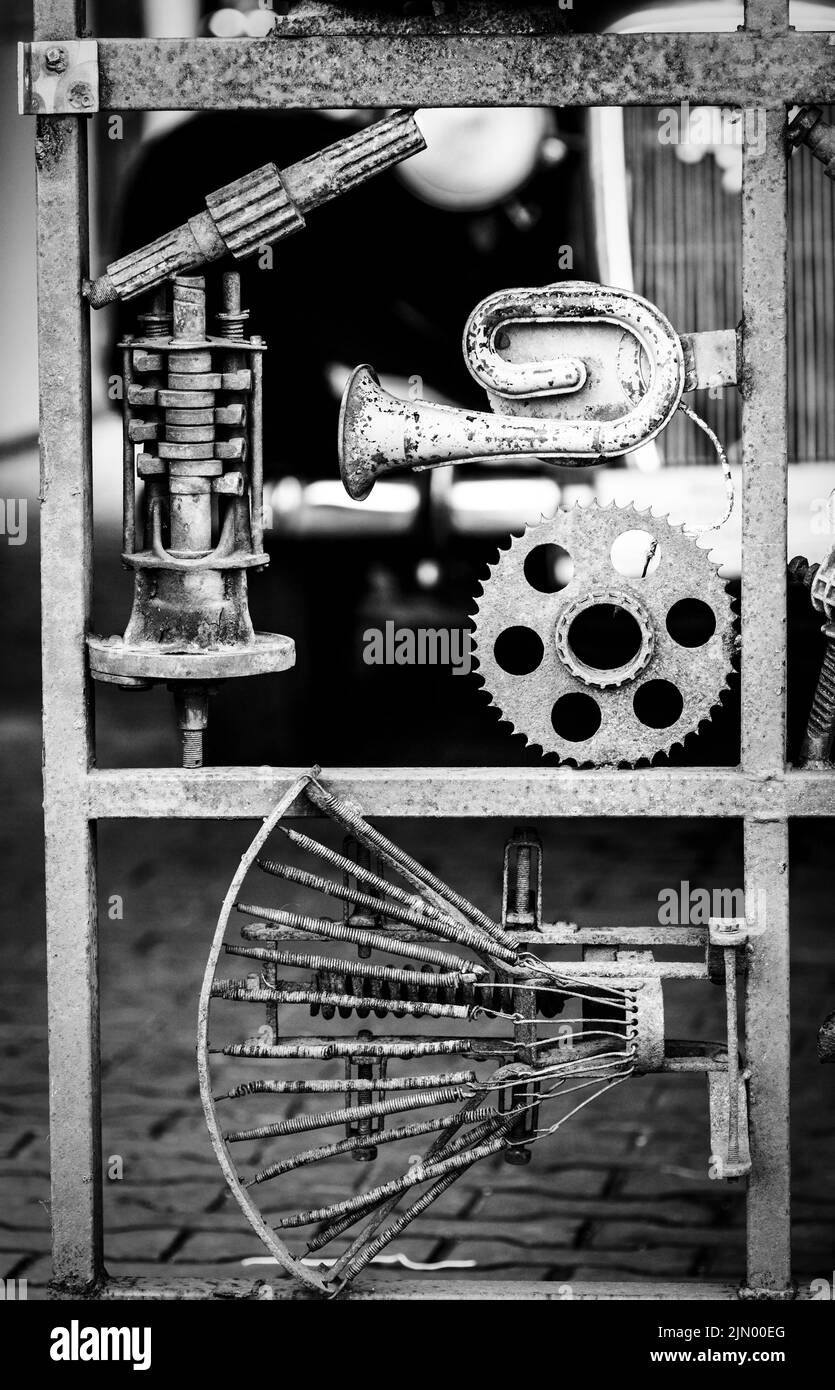 Metal scrap installation made of old cars and motorcycles parts Stock Photo
