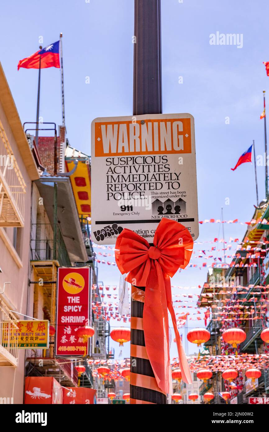 San Francisco, USA - May 19, 2022: warning sign from San Francisco police that suspicious activities should be reported immediately to police. Stock Photo