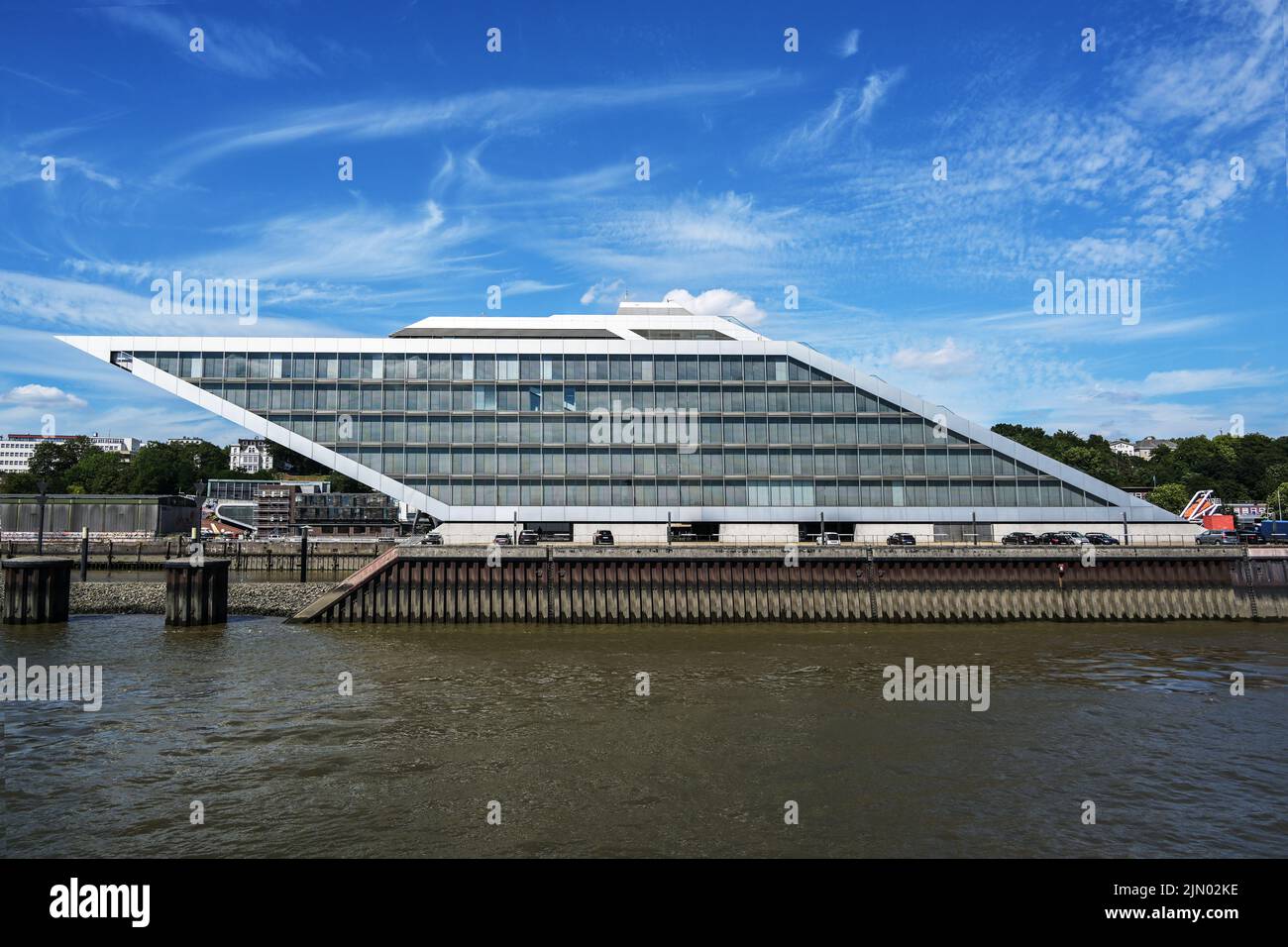 Dockland Hamburg, Germany, modern office building in the shape of a parallelogram, famous landmark and popular viewing platform, blue sky with clouds, Stock Photo