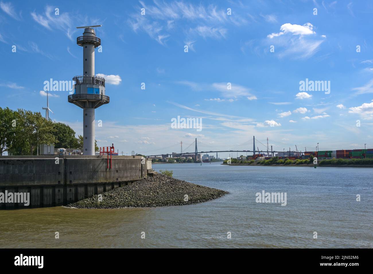 Radar tower with water level indicator at the Steinwerder coal ship harbor in the cargo port of Hamburg, Koehlbrand Bridge over the river Elbe in the Stock Photo