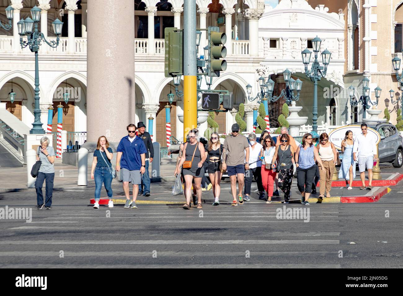 Las Vegas, USA - May 24, 2022: tourists in Las Vegas crossing the street in daytime at a pedestriam crossing. Stock Photo