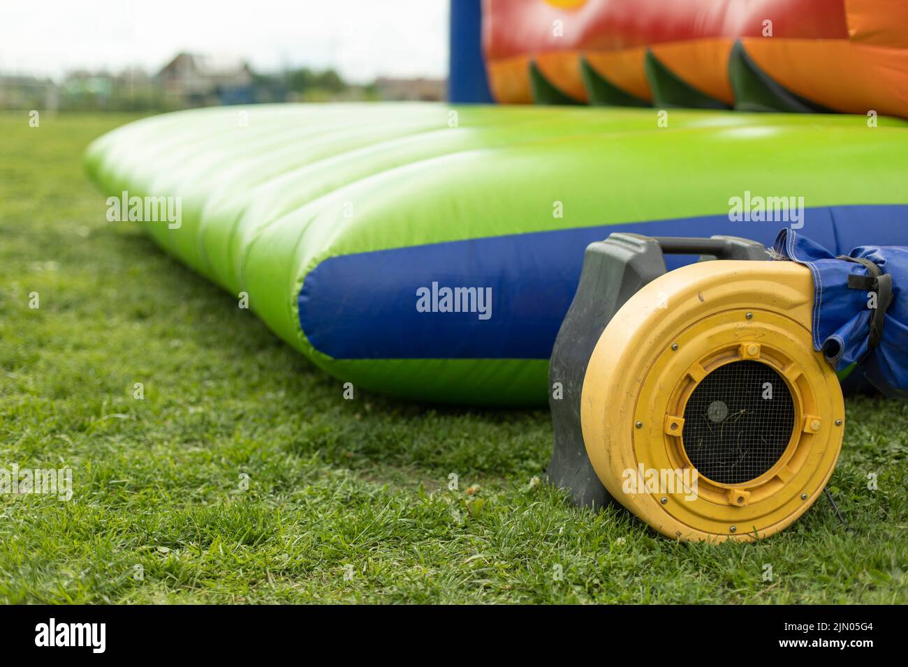 Air generator inflates obstacle course. Electric generator yellow ...