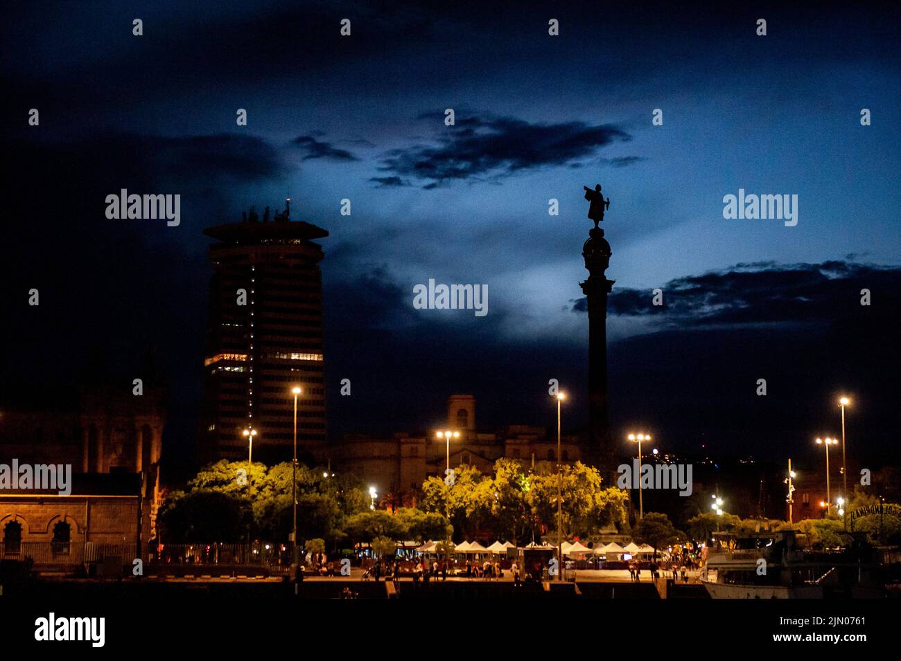At the bottom of La Rambla the statue of Christopher Columbus and the Edifici Colon tower are seen amid the clouds after a storm at the  Port Vell in Stock Photo