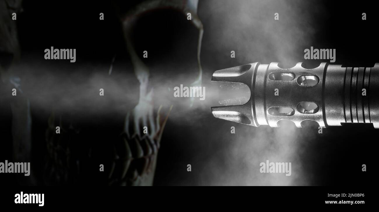 Muzzle of a firearm with smoke being forced out on a black background with room for copy Stock Photo
